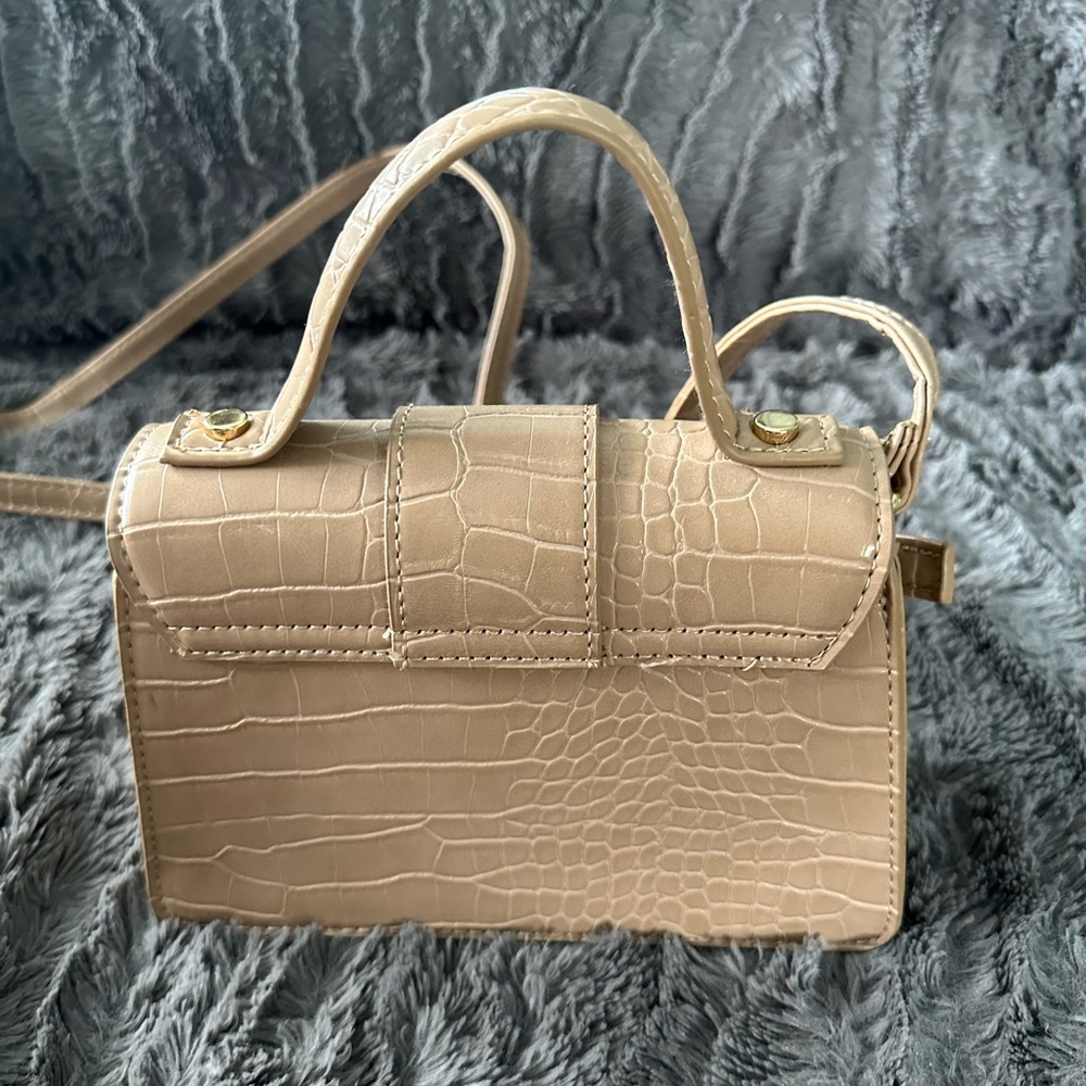tan purse with gold accent detailing